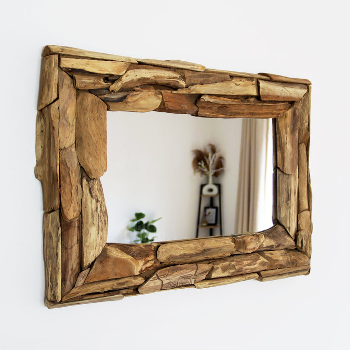 Rectangular wall mirror crafted from reclaimed teak wood, perfect for rustic home decor in a living room or entryway.