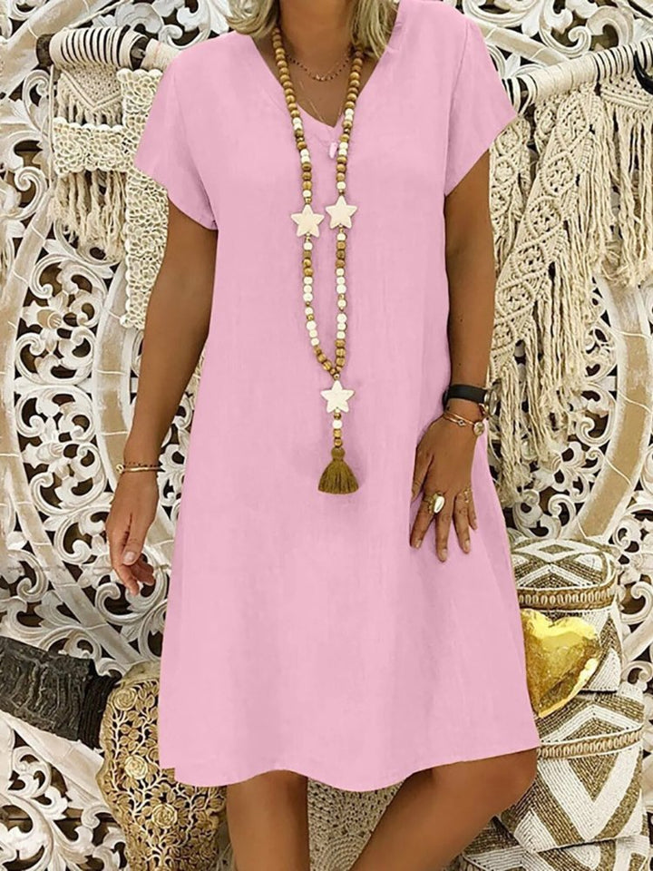 Comfortable women's short sleeve V-neck A-line mini dress, perfect as a versatile summer casual dress.
