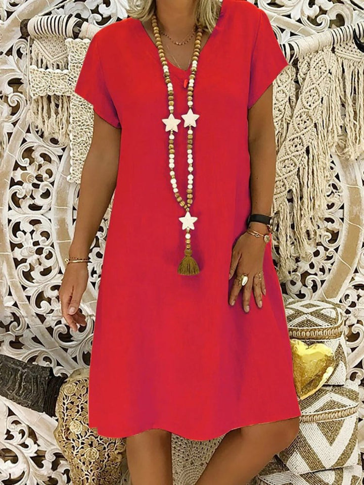 Flattering women's V-neck mini dress, A-line silhouette with short sleeves, ideal for elegant everyday style.