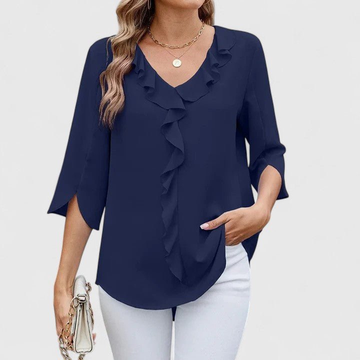 Model wears elegant women's ruffle V-neck half-sleeve blouse, highlighting its flattering silhouette.