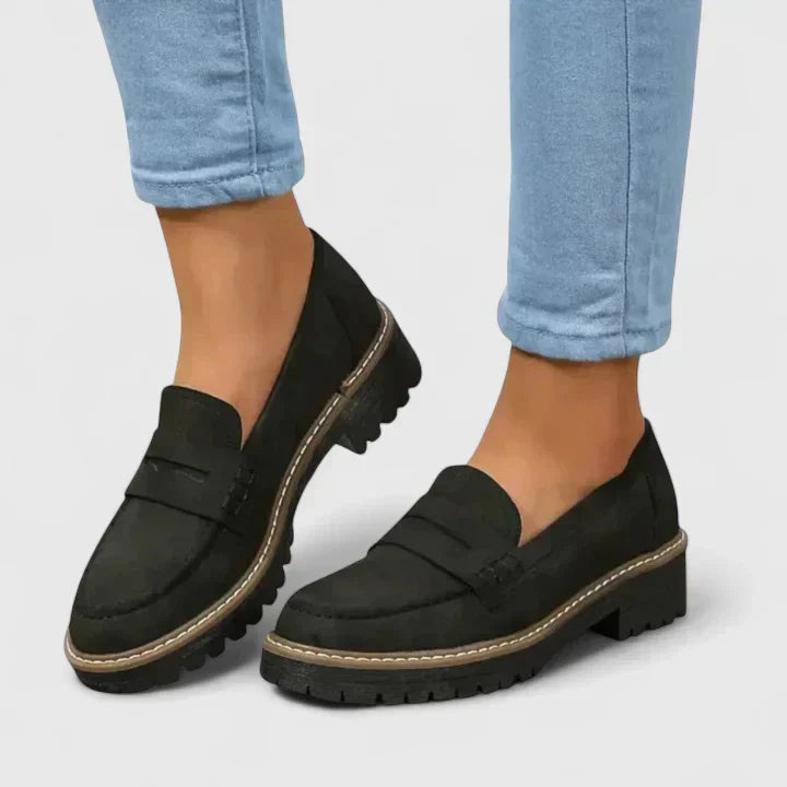 Women's elegant black orthopedic loafers, offering supreme comfort & supportive slip-on style for daily wear.