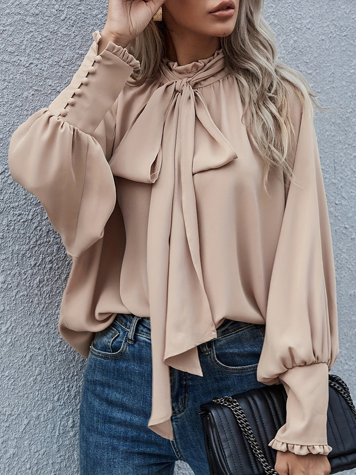 Dressy long sleeve women's blouse with sophisticated tie neck detail, perfect for formal wear.