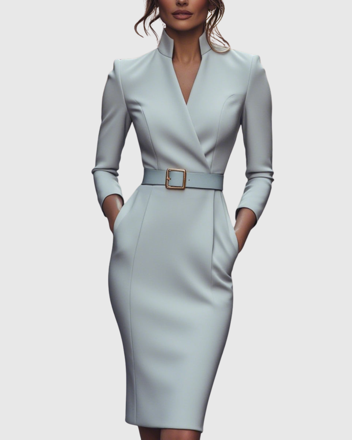 Hemline of a women's midi dress, emphasizing its elegant length and structured pencil fit. Versatile.