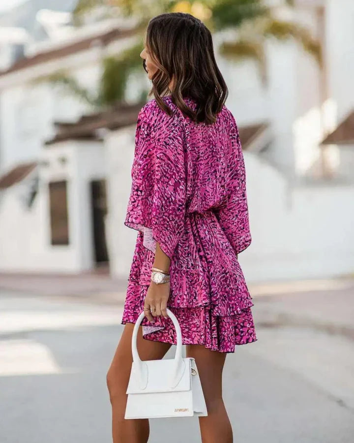 Colorful flowy women's summer beach dress, vibrant pattern, stylish and comfortable for warm weather.