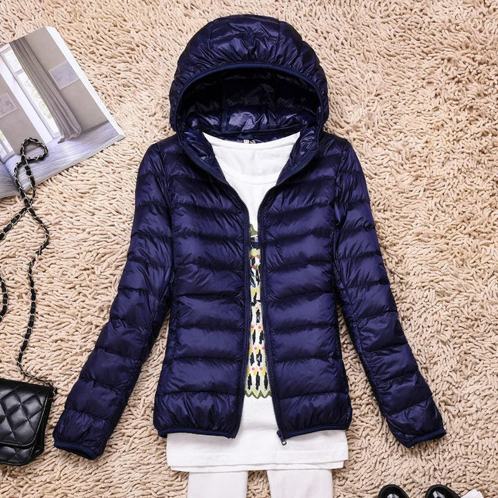 Back view of a women's ultralight puffer jacket. Essential warm & packable winter coat.