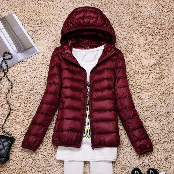 Texture detail of ultralight fabric on women's puffer jacket. Durable winter coat material.