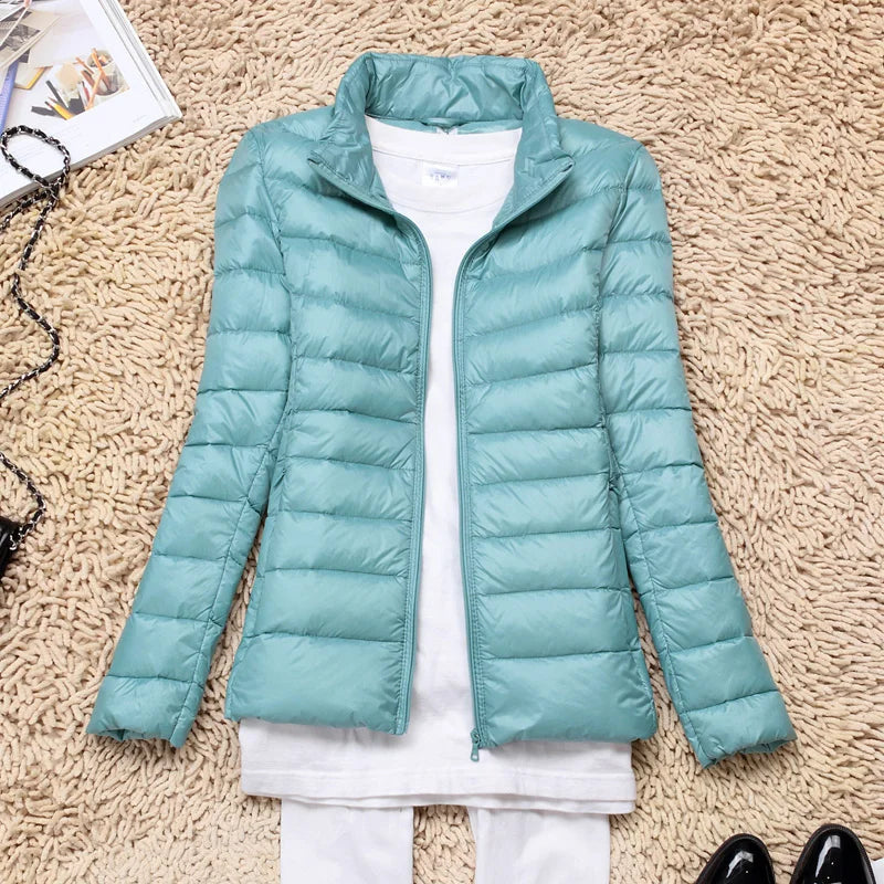 Woman hiking in a warm, packable hooded puffer jacket. Ideal travel jacket for active women.