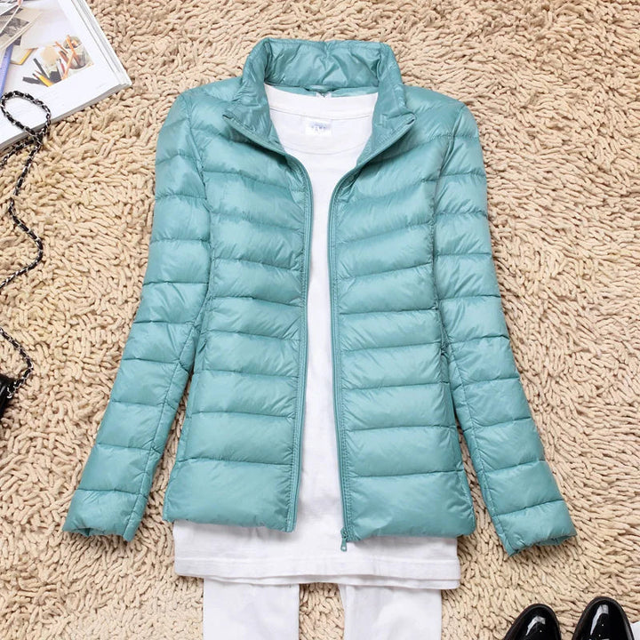 Woman hiking in a warm, packable hooded puffer jacket. Ideal travel jacket for active women.