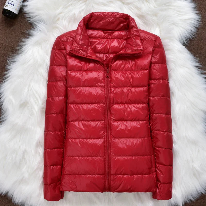 Woman showcasing the functional pockets of her packable puffer jacket. Convenient travel coat.