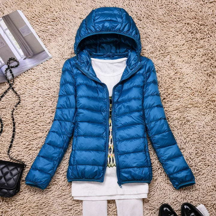 Packable women's puffer jacket easily zips into its pouch. Perfect lightweight travel jacket.