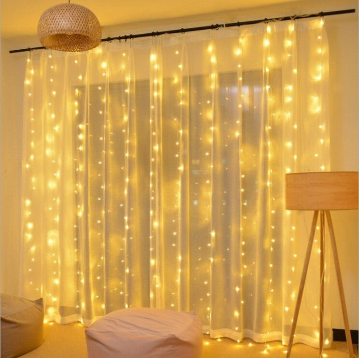 Enchanting warm white LED fairy curtain lights, ideal for wedding or party decorations.