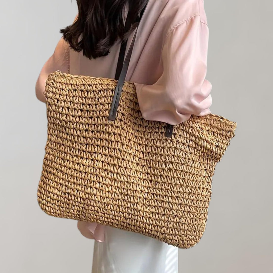 Women's vacation-ready oversized straw tote bag. Woven for a chic summer beach and travel accessory.