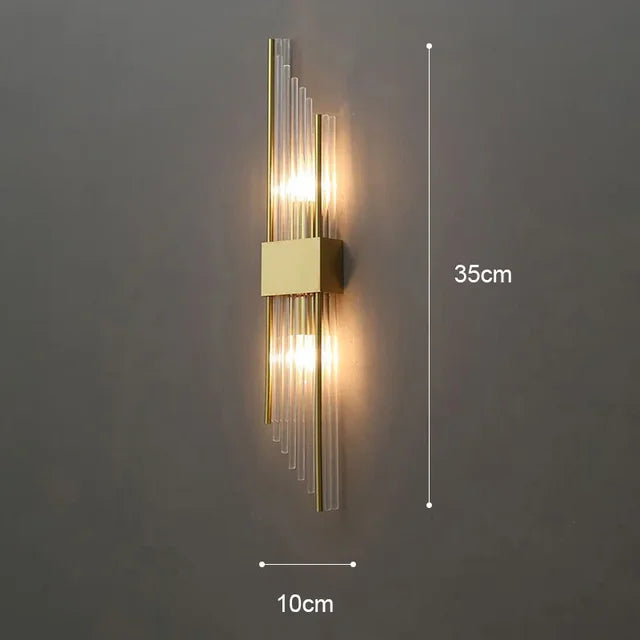 Up-close of the exquisite crystal glass detail on a gold finish LED wall sconce. Luxury home decor.