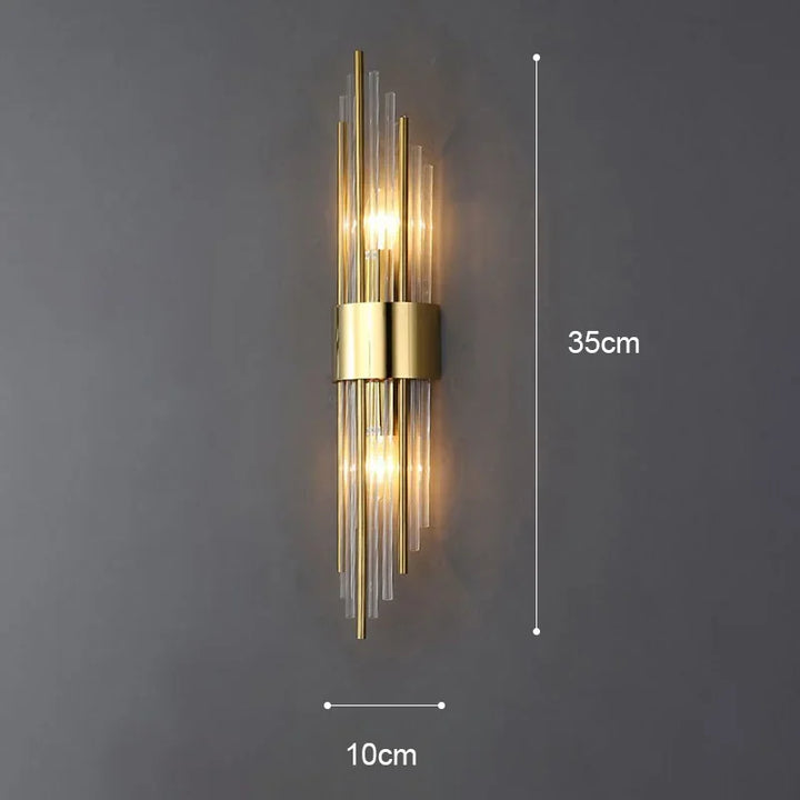 Bright LED wall sconce for living rooms. Elegant gold finish, modern design, & crystal highlights.