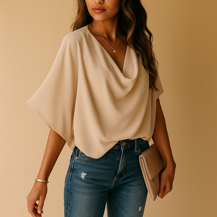 Lightweight flowy women's blouse with elegant batwing sleeves, suitable for warm weather.