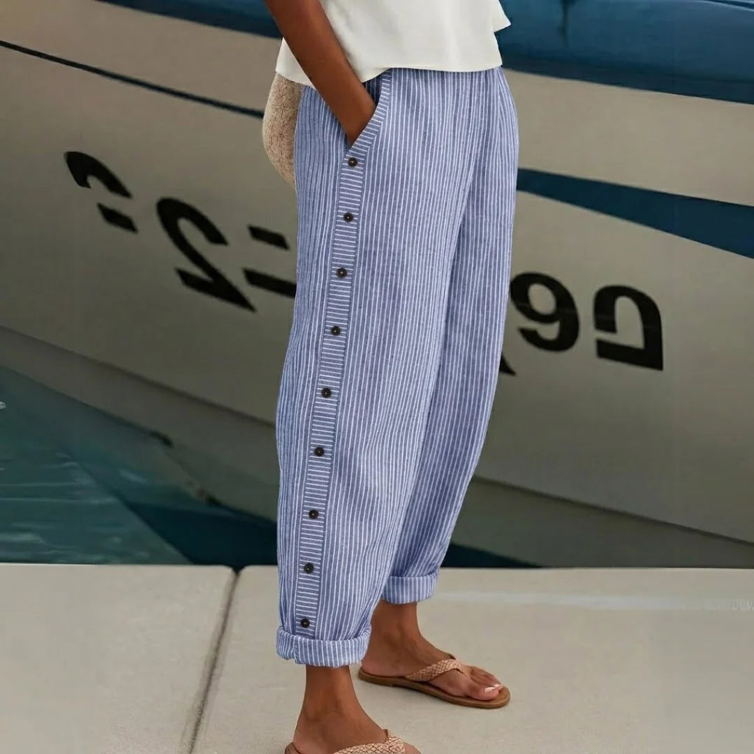Fashionable high-waisted striped wide-leg trousers for women. Elegant and comfortable, great for modern office wear.