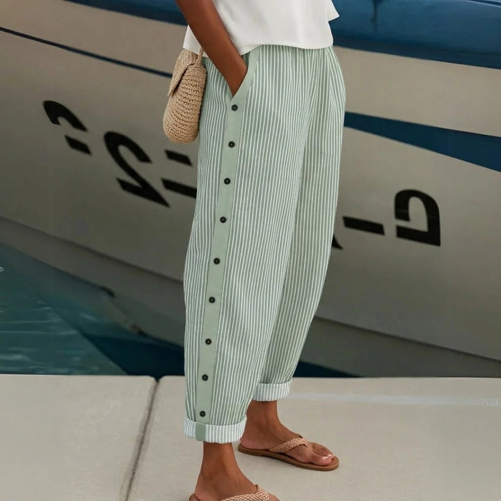 Women's elegant high-waisted striped wide-leg trousers in a comfortable, flowing fabric, styled for a modern look.
