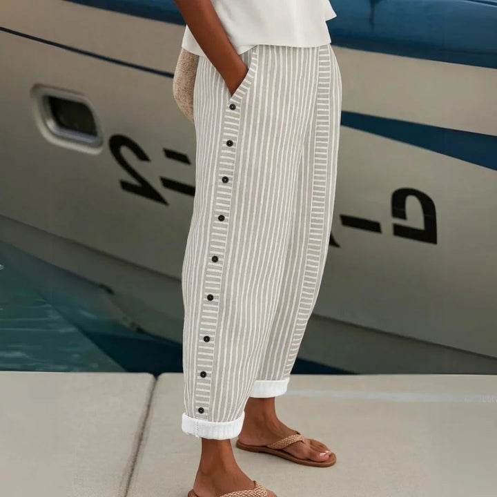 Elegant women's striped high-waisted wide-leg trousers, a chic and versatile choice for office or casual fashion.