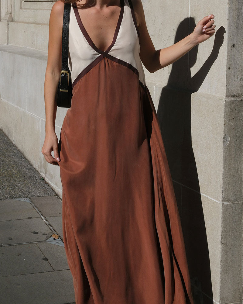 Sleek silhouette of women's color block V-neck maxi dress, a modern elegant fashion piece.