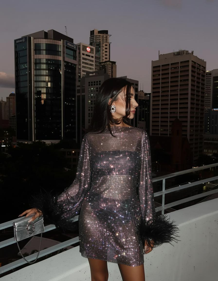 Glamorous women's metallic mini party dress with stylish feather accents, special occasion wear.
