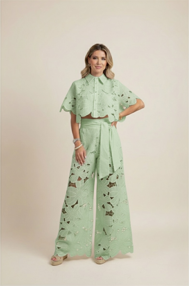 Detailed view of delicate floral embroidery on women's chic top & wide-leg pants set. Elegant detail.