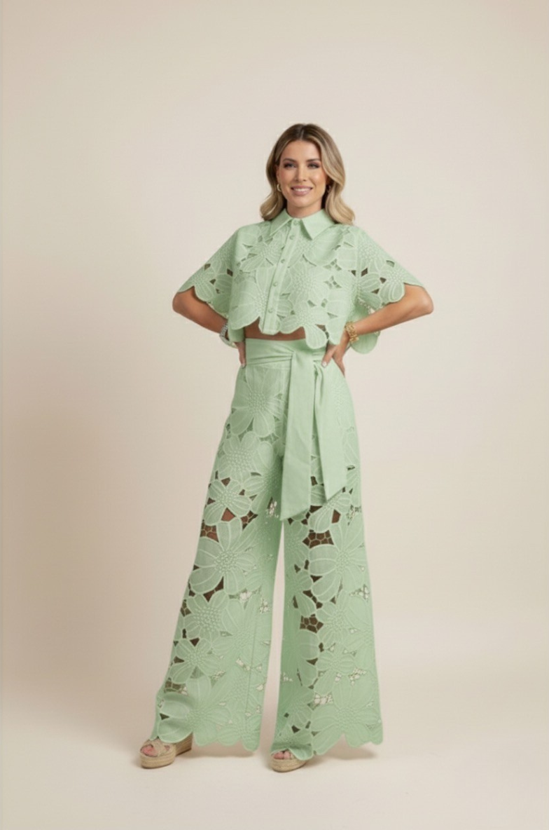 Model wearing elegant women's floral embroidered top & wide-leg pants set. Chic spring/summer outfit.