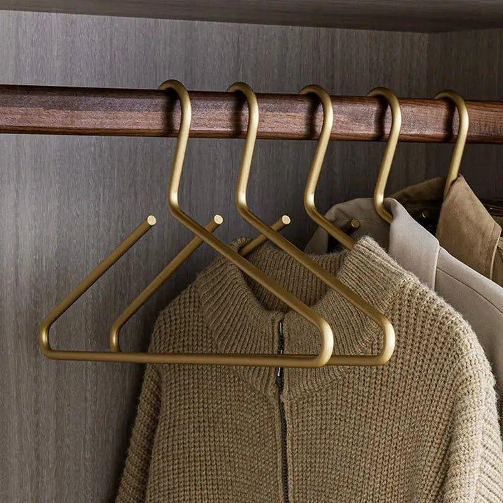 Luxe gold metal non-slip hangers for heavy coats & delicate garments. Elegant wardrobe organization, a true closet refresh.