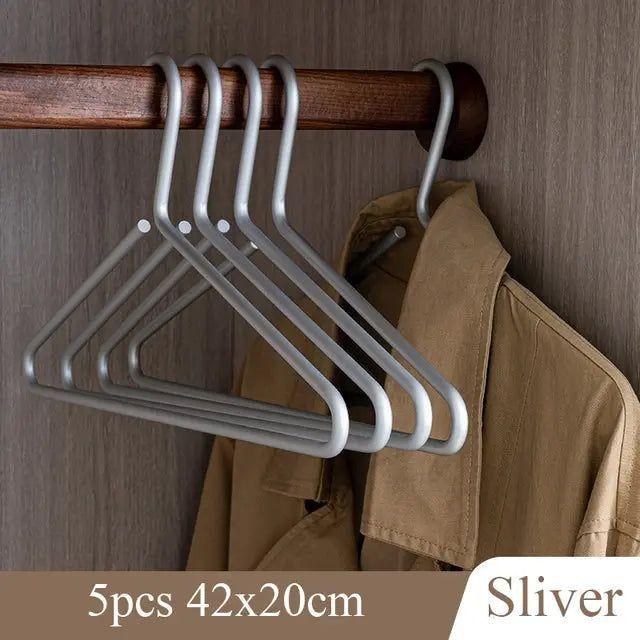 Closet transformation with sleek, non-slip metal hangers, creating a tidy & organized space for all clothes. Luxury home solution.