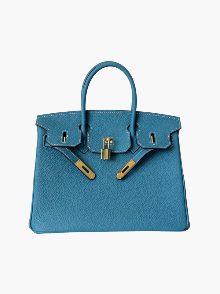 Fashionable women's leather handbag with a unique closure, ideal for modern elegance.
