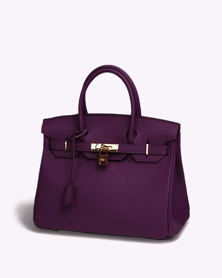 Women's elegant leather purse with a clean design and eye-catching closure detail.