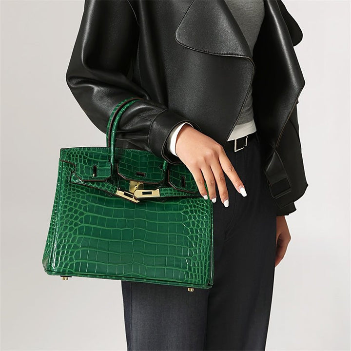 Ladies' elegant leather handbag, showcasing a refined design and distinctive chic closure detail.