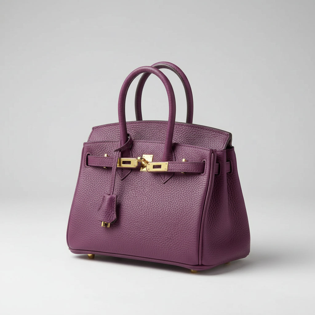 Elegant women's leather handbag with a chic gold closure, perfect for shoulder or crossbody wear.