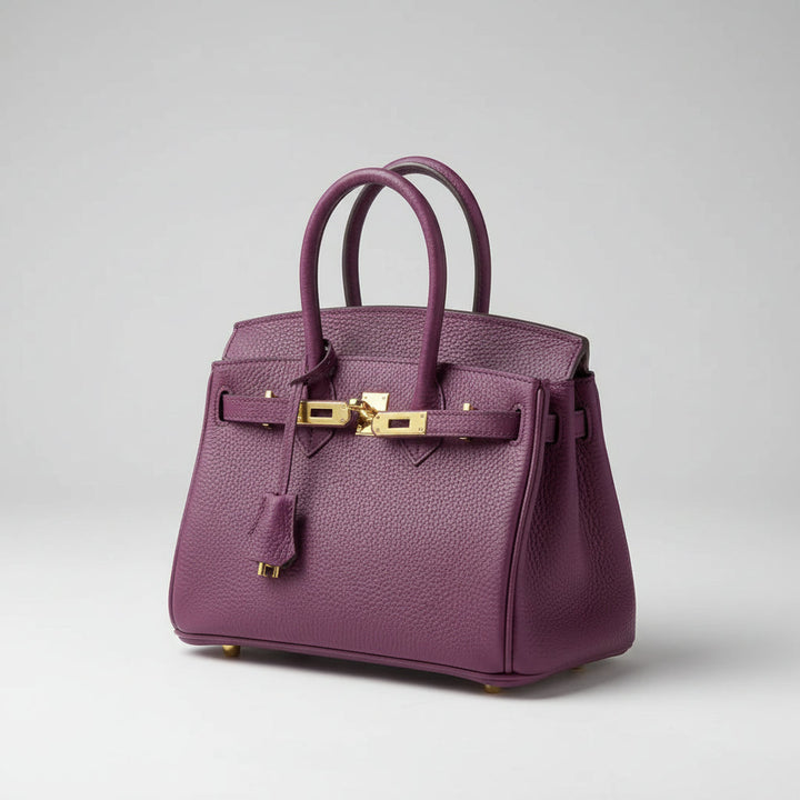 Elegant women's leather handbag with a chic gold closure, perfect for shoulder or crossbody wear.