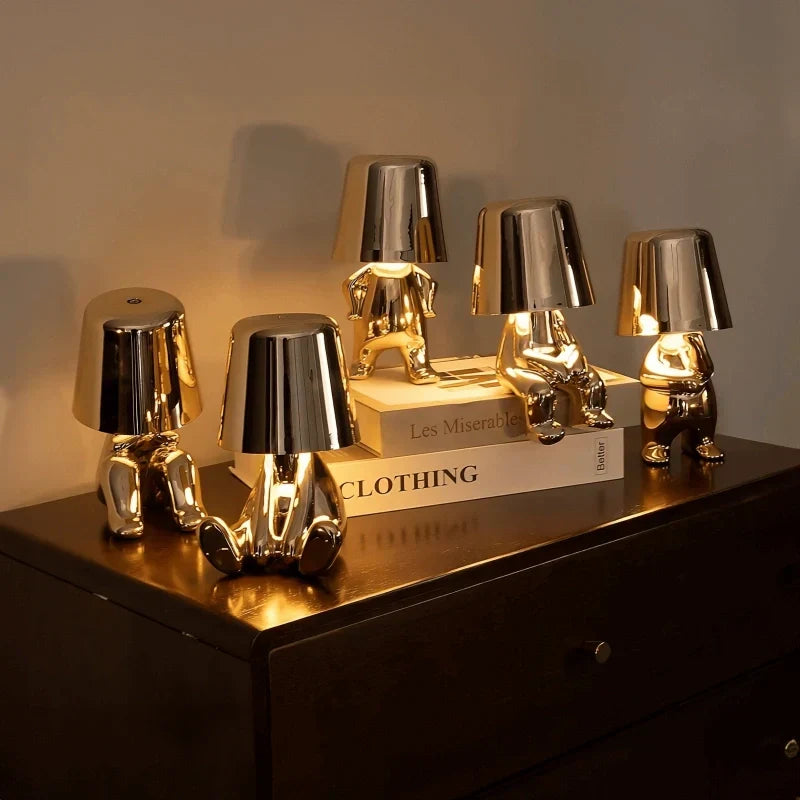 Cordless LED lamp, artistic figurine design. USB rechargeable for portable, decorative lighting.