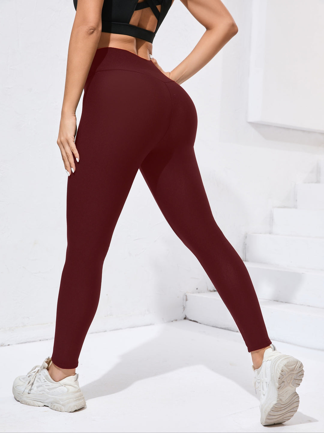 Woman stretching in comfortable women's activewear leggings, ideal for yoga, running & high-performance workouts. Flattering.
