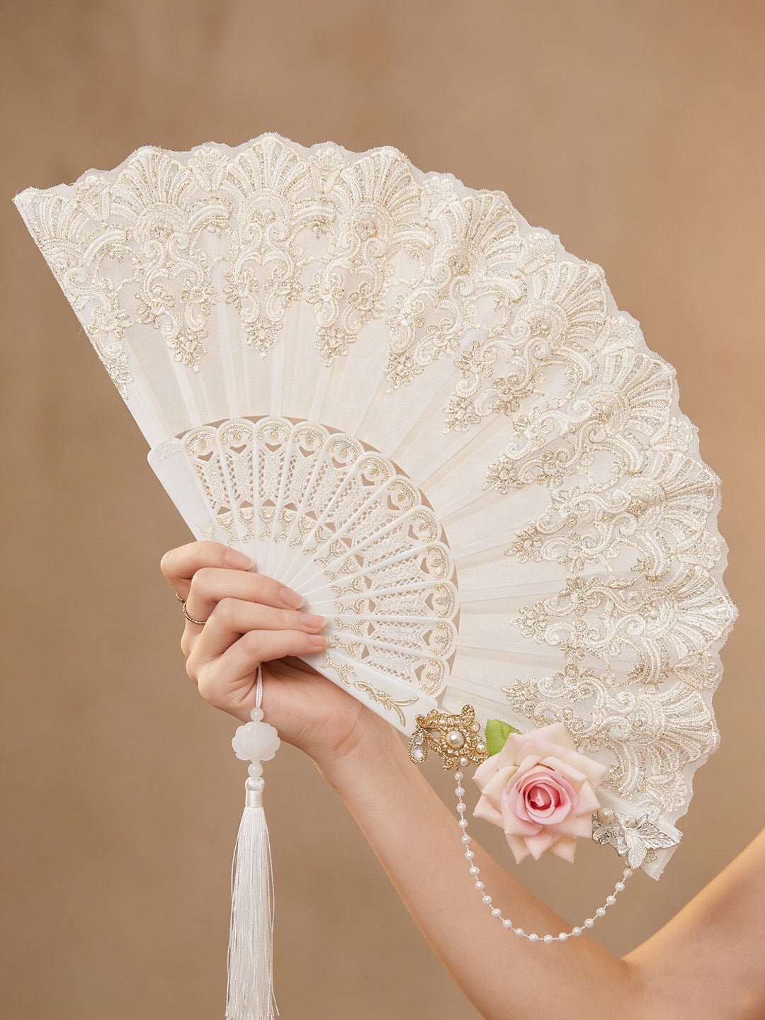 Close-up of a handcrafted floral lace folding fan. Delicate women's accessory for elegant wedding & party decor.