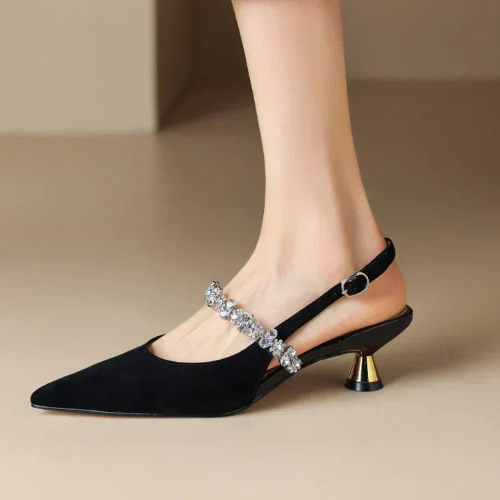Comfortable low heel slingback pumps for women, pointed toe, black with sparkling crystal details.