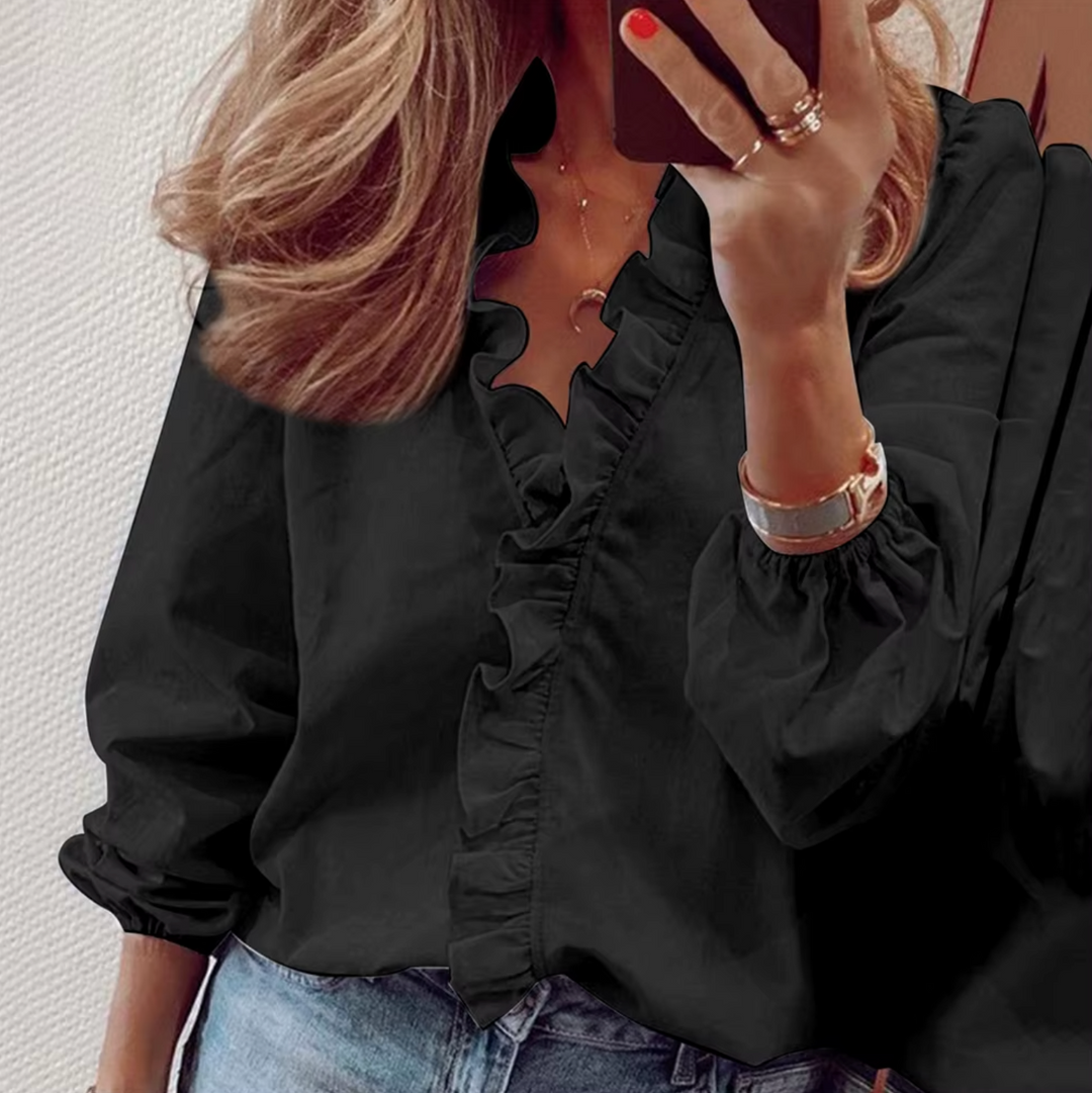 Versatile women's long sleeve ruffled blouse. Comfortable V-neck top ideal for elegant office wear or casual chic styles.