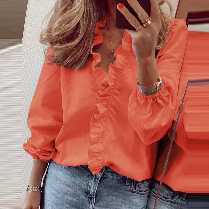 Chic women's V-neck blouse with long sleeves and delicate ruffles. An elegant and comfortable top for any occasion.