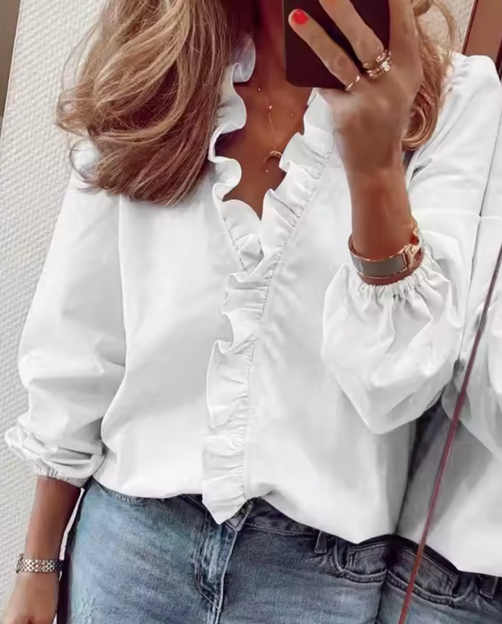 Modern women's fashion blouse: elegant ruffled long sleeves and a V-neck design. Perfect for stylish casual or office wear.
