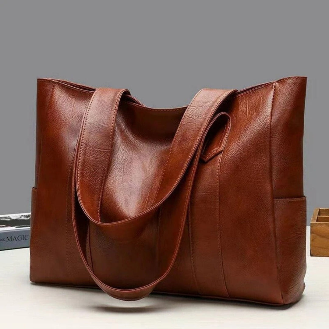 Front view of a women's classic large vintage leather tote bag with sturdy handles, versatile shoulder bag.