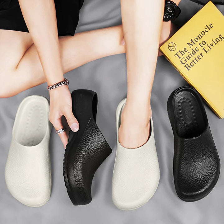 White unisex waterproof clogs for hospital or salon use. Non-slip, comfortable, safety-rated professional footwear.
