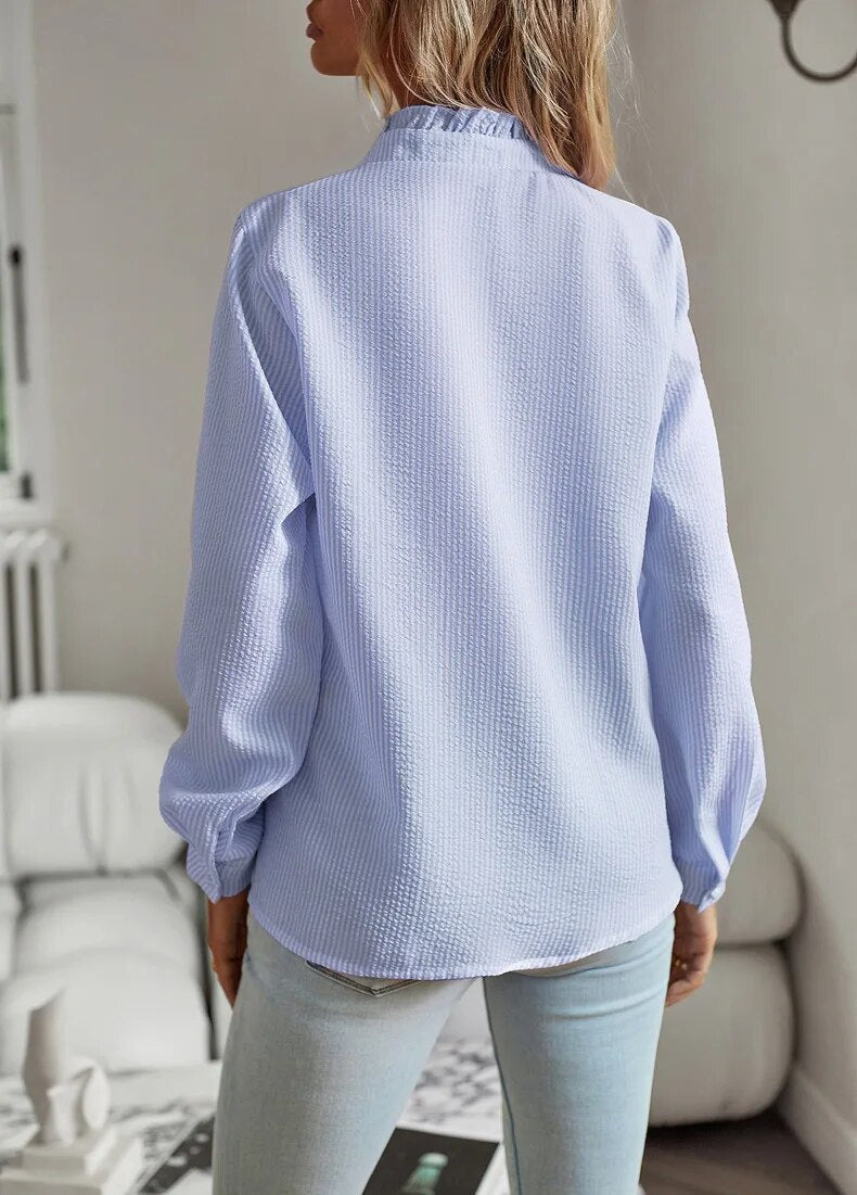 Women's short sleeve collared blouse with delicate ruffles, offering a feminine and comfortable fit.