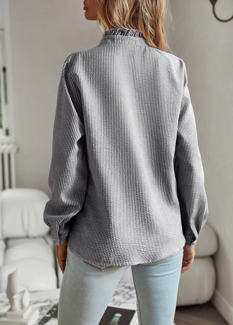 Comfortable women's ruffled polo blouse, combining everyday wearability with chic, elegant style.