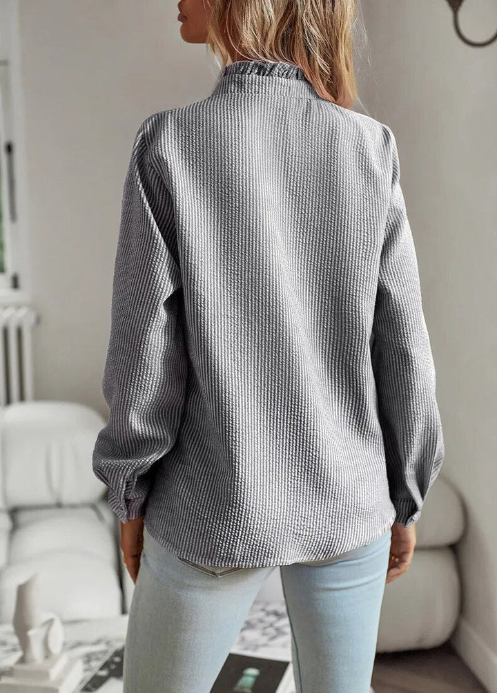 Comfortable women's ruffled polo blouse, combining everyday wearability with chic, elegant style.