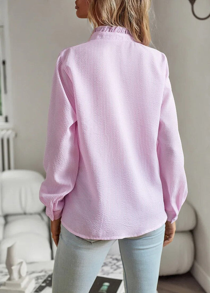 Stylish women's polo blouse with elegant ruffled detailing and a comfortable short-sleeve design.