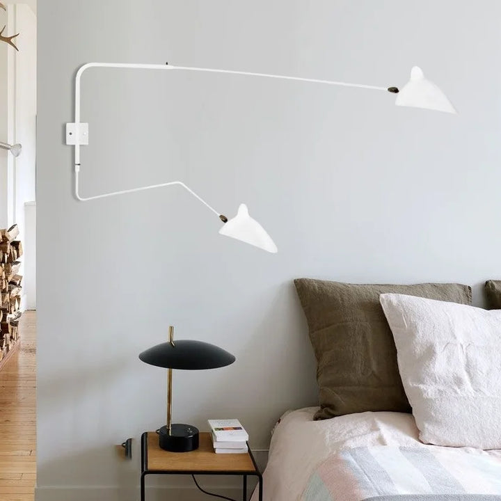 White adjustable wall lamp, offers bright reading light & modern Scandinavian home decor accent.