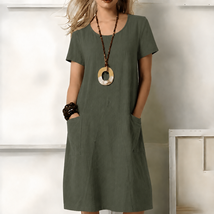 Women's relaxed fit midi dress with short sleeves and convenient side pockets, perfect for casual everyday comfort.