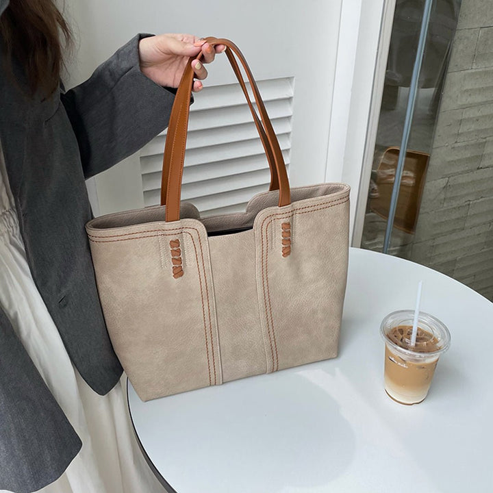 Front view of a versatile women's large vegan leather tote, perfect as a minimalist work or travel bag.