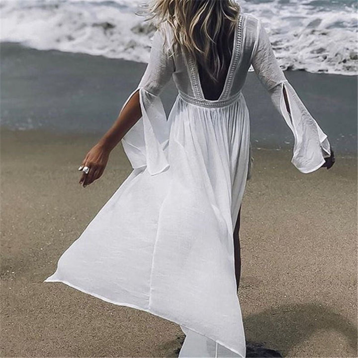 Women's flowy open-back maxi beach tunic cover-up for elegant resortwear.